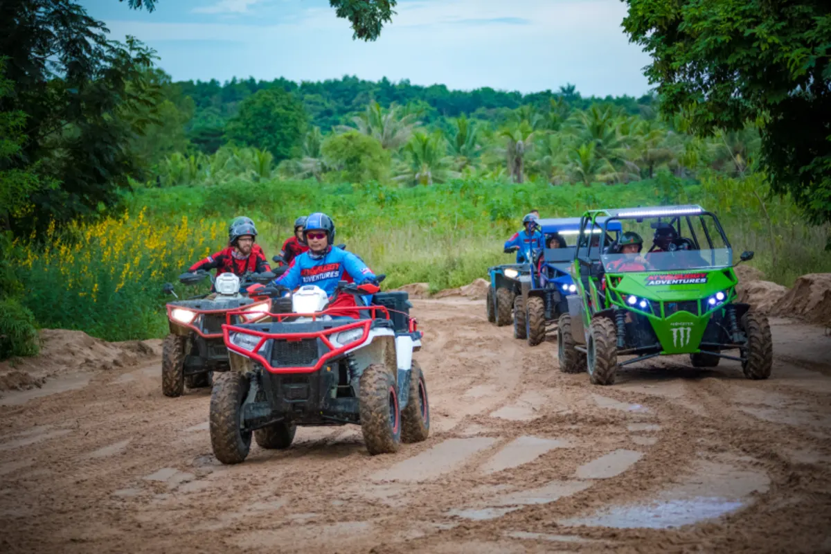 Mixed fleet of ATVs and buggies on a muddy trail