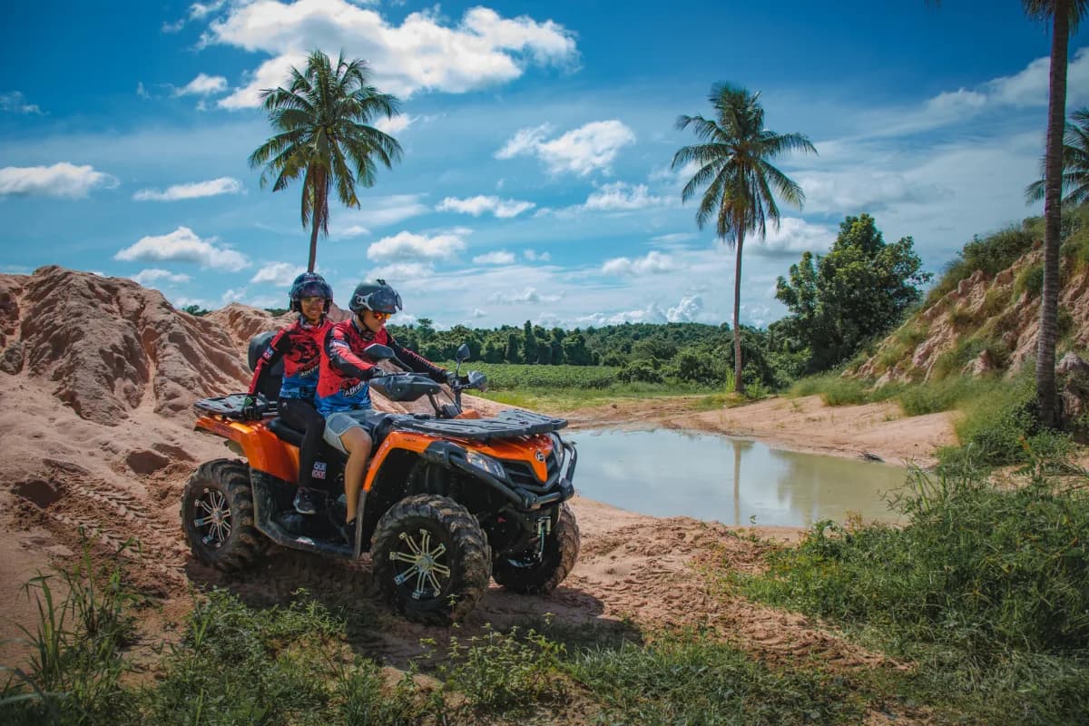 VIP Private ATV Tour through tropical scenery with palm trees and blue sky