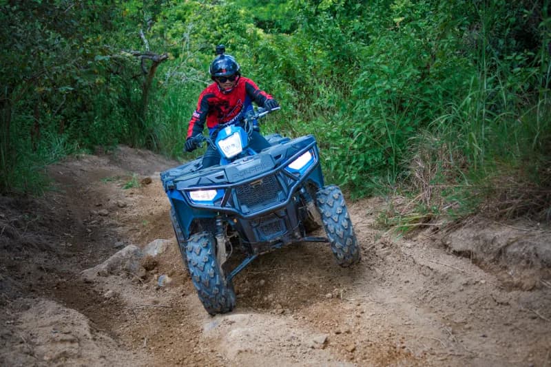 ATV rider overlooking dramatic cliff scenery in Thailand